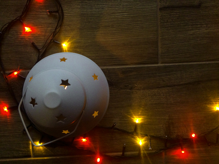 Colored lights Christmas garlands. Christmas background. planked wood with lights and free text spaceの写真素材
