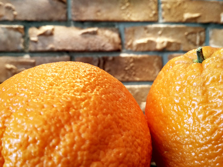 Orange fruits background many orange fruits - orange fruit on brick wall backgroundの写真素材