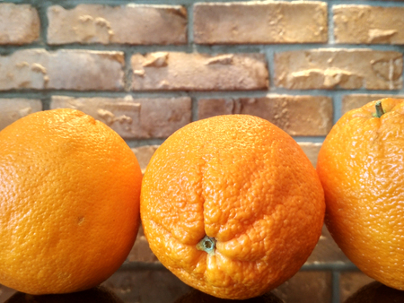 Orange fruits background many orange fruits - orange fruit on brick wall backgroundの写真素材
