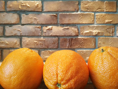 Orange fruits background many orange fruits - orange fruit on brick wall backgroundの写真素材