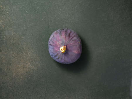 Fresh ripe figs on a black background, top view.