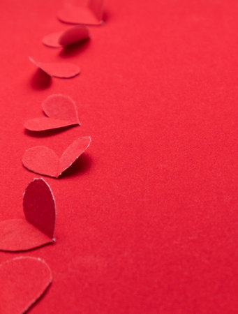 Red paper hearts on redの写真素材