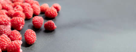 Fresh and sweet raspberry in a dark background. Selective focus.の写真素材