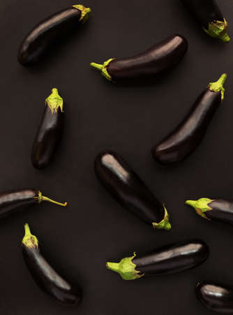 Raw ripe eggplants on black background. Top view, copy space.の写真素材