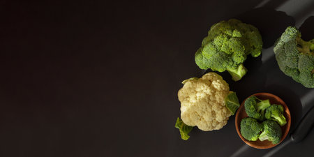 Broccoli and cauliflower on dark background, top view.の写真素材