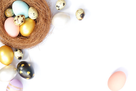 Easter eggs, flowers on white background. Flat lay, top view, copy space. Easter day.の写真素材