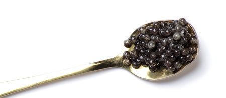 Black sturgeon caviar in gold spoon. Sturgeon caviar on a white backgroundの写真素材