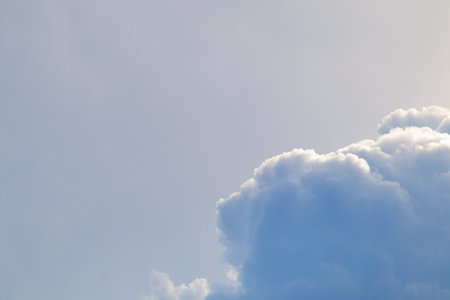Blue sky with clouds and sun, the sunset behind the clouds.