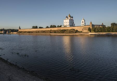The City Of Pskov. Russia. Pskov Kremlin. Holy Trinity Cathedral and bell tower from the side of the Great river at sunset.のeditorial素材