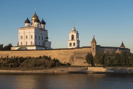 The City Of Pskov. Russia. Pskov Kremlin. Holy Trinity Cathedral and bell tower from the side of the Great river at sunset.のeditorial素材