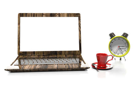 alarm clock, laptop and cup of hot thea on table