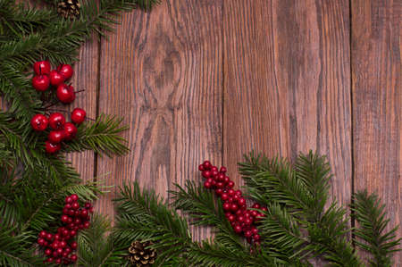 Christmas fir tree on wooden background with space for your textの写真素材