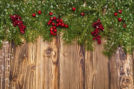 Christmas fir tree on wooden background with space for your textの写真素材