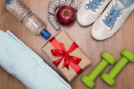 image of fitness accessories and gift boxe on a wooden backgroundの写真素材