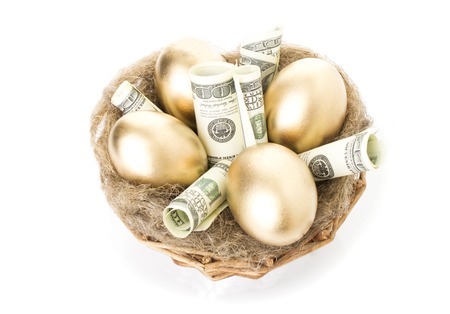 Nest with golden eggs on a white backgroundの写真素材