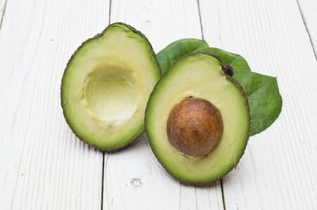 Avocado isolated on a white wooden backgroundの写真素材