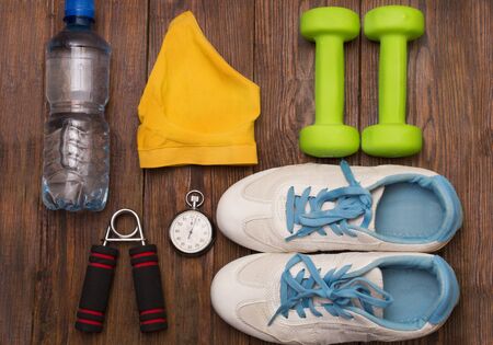 fitness equipment and healthy food on a wooden backgroundの写真素材