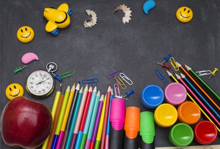 School supplies on blackboard background