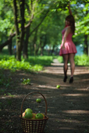 girl offers an apple. outdoor portraitの写真素材