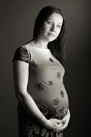attractive girl waiting for child. studio shotの写真素材