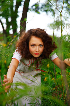 girl looking with interest in camera. outdoor shotの写真素材