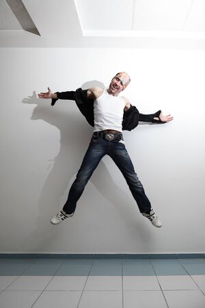 happy handsome man jumping. indoor shotの写真素材