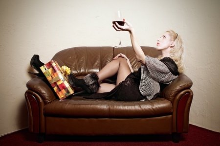 portrait of attractive girl with glass of wine and gift boxの写真素材