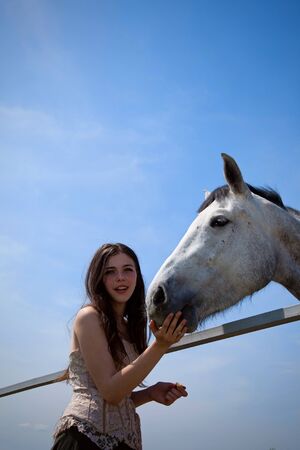portraite of attractive girl and horse. outdoor shotの写真素材