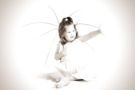 portrait of attractive young girl in white dress with umbrellaの写真素材