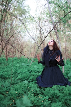 young woman in old style black dress and veilの写真素材