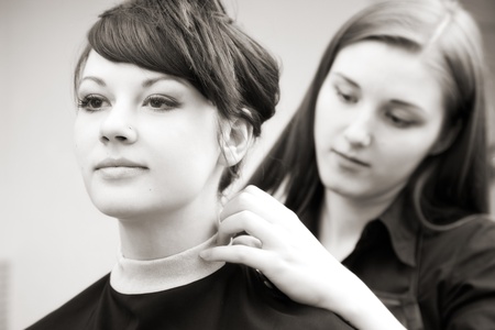 creating hairstyles hairdresser at salon. indoor shotの写真素材