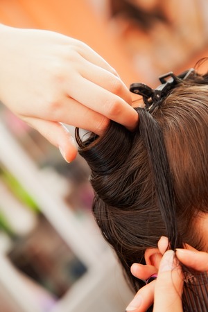 creating hairstyles hairdresser at salon. indoor shot