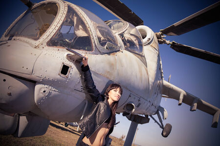 A girl portrait on a old helicopter backgroundの写真素材