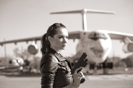 portrait of attractive woman near plane. sepiaの写真素材