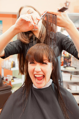 creating hairstyles hairdresser at salon. indoor shotの写真素材
