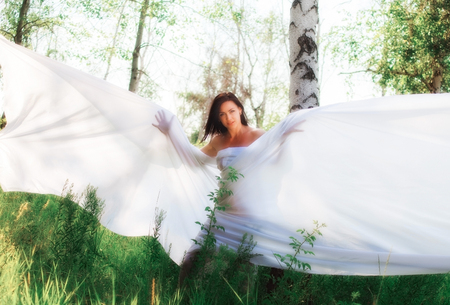 girl wrapped in white fabric. outdoor shotの写真素材