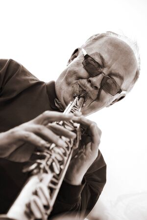 musician, trumpeter playing the instrument at sunset