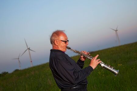 musician, trumpeter playing the instrument at sunsetの写真素材