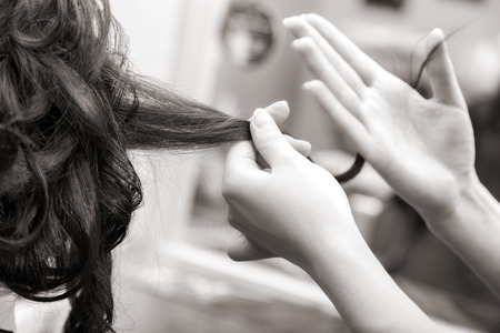 creating hairstyles hairdresser at salon. indoor shotの写真素材