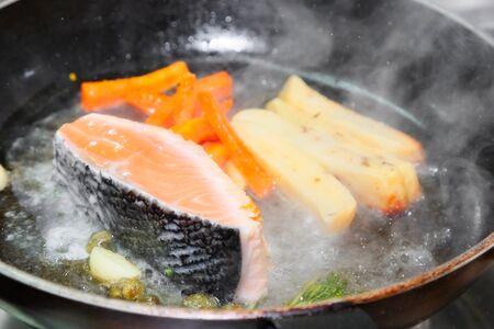 Fillet of Norwegian salmon with garlic, confit tomatoes and pestoの写真素材