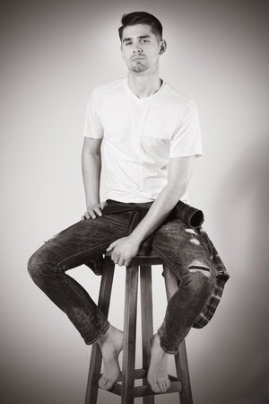 stylish young brunet in white t-shirt and jeansの写真素材