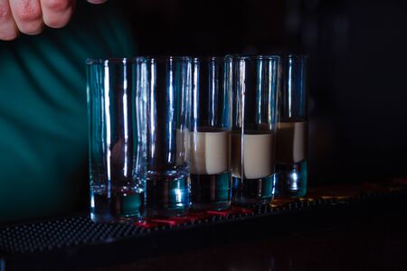 Preparation of shots cocktails. Close-up
