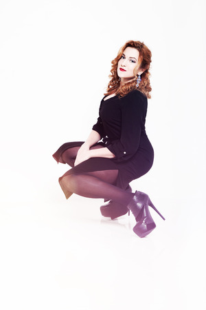 portrait of a beautiful red-haired girl on a white background.の写真素材