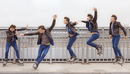 young attractive guy rollerblading in the parkの写真素材