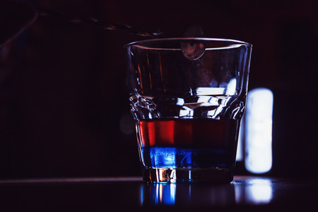 exotic cocktail with red and blue layers. close-upの写真素材
