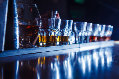 beautiful, golden row of cocktails on the bar