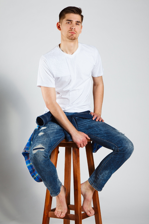 stylish young brunet in white t-shirt and jeansの写真素材