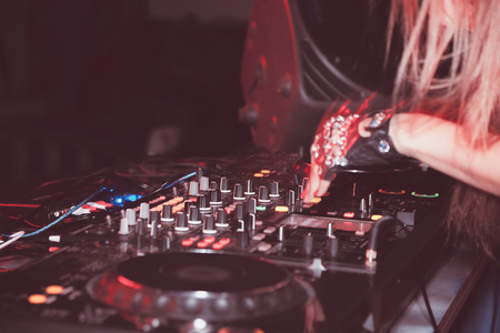 DJ mixes tracks at a party. DJ control panelの写真素材