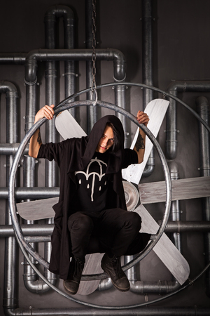 young men in black cloth in metal circleの写真素材