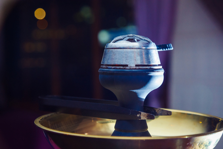 the embers in the bowl of the hookah. close-up
